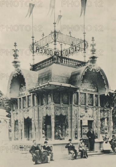 View of the pavilion of cocoa manufacturer Blooker at the Antwerp World Exhibition in 1894, Pavillon Cacao Blooker, Exposition Universelle d'Anvers 1894, page, photomechanical print, photographer: Charles Bernhoeft, Antwerp, cliché maker: Charles Bernhoeft, Luxembourg (Belgian province), 1894, Charles Bernhoeft, photographer, cliché maker, paper, collotype, photoprint, height 215 mm x width 152 mm, Print on third unnumbered page after page 98., shop, store, world fair, world exhibition, chocolate (solid), World Exhibition 1894 (Antwerp), Period, 1894-05-05 - 1894-11-05, A vintage ornate pavilion with a decorative roof featuring patterned shingles and carved cresting, topped by a wrought iron framework with spires and flags, stands with tall windows draped in patterned curtains and supported by slender decorative columns; several people sit and stand in front of the pavilion, dressed in period clothing including long coats, hats, and a dress with an apron, some seated at small round tab...