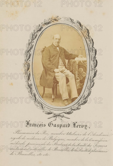 Portrait of François-Gaspard Leroy, François Gaspard Leroy, photograph, page, c. 1862 - in or before 1867, photographer, paper, albumen print, height 85 mm x width 55 mm, Photo opposite title page., Person, François-Gaspard Leroy, historical persons, An oval-framed sepia photograph centered on an aged paper shows a seated older man with a receding hairline and mustache, wearing a dark coat over patterned waistcoat and light trousers, seated on an ornate wooden chair with one hand resting on his knee and the other on a patterned tablecloth beside a small stack of books, the oval frame embellished with a drawn laurel wreath and ribbon, all set against a pale background with scattered age spots.
