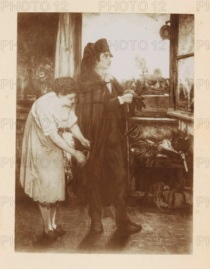 Photo reproduction of a painting of an undertaker and a woman by Willem Linnig (II), photograph, reproduction, page, photographer: Alexandre van Antro, after painting by Willem Linnig (II), c. 1891 - in or before 1896, paper, daylight collodion silver print, height 159 mm x width 118 mm, adult woman, undertaker, mortician, A sepia-toned scene shows two figures standing inside a room by an open window; a woman in a light dress with short sleeves leans forward holding a basket while a man in a dark cloak and hat faces the window with gloved hands clasped, his profile visible. The window reveals a distant landscape with trees and a cluster of buildings. Inside, shelves and a table near the window hold various objects including large birds and other items that appear to be poultry. A hanging pan is visible near the top of the window frame. The floor is wooden and the edges of a curtain and a vase of flowers can be seen behind the woman.