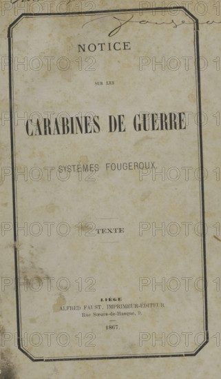 Notice sur les carabines de guerre systèmes fougeroux, Rifle Butt, book, name: '... Fougeroux', inscription: 'Echange Ministère de la defense', publisher: Alfred Faust, Liège, 1867, textile materials, pasteboard, paper, linen (material), printing, spanish marbled paper, albumen print, height 253 mm x width 178 mm x thickness 18 mm, A vertically oriented aged paper page with a rectangular double-line border near the edges and signs of foxing and stains across its surface, containing several lines of printed text in different typefaces centered on the page, a small horizontal decorative line element, and a faded handwritten flourish near the top edge.