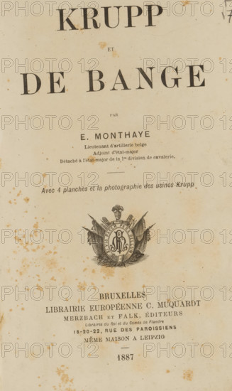 Krupp et de Bange, par E. Monthaye, book, annotation: 'MAR, 2000', writer (clerical worker): E. Monthaye, publisher: Charles Muquardt, Brussels, 1887, writer (clerical worker), textile materials, pasteboard, paper, linen (material), printing, decorated paper, lithography, albumen print, height 217 mm x width 144 mm x thickness 24 mm, The image shows an aged book page with a large title area at the top and smaller lines of printed text below, all on yellowed paper that has numerous brownish foxing spots and stains scattered across the surface; near the center there is a decorative emblem featuring a circular medallion with ornate detailing and draped flags, and below that the page continues with more printed lines and additional foxing, the overall appearance showing worn edges and a vertical orientation.