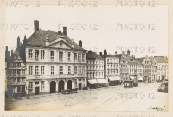 View of the Warehouse on the Korenmarkt in Ghent, photograph, page, annotation: 'Le 'Packhuys' (voir page 17)', photographer: Edmond Sacré, Ghent, c. 1894 - in or before 1899, paper, gelatin silver print, developing gelatin silver print, height 114 mm x width 175 mm, street, large-scale structure for storage, eg: warehouse, depot, silo, A wide street scene showing a row of multi-storey buildings with ornate facades and varying rooflines, some with decorative gables and chimneys, and a large classical building with tall windows and arched ground-floor openings in the foreground, horse-drawn carts parked along the curb, small awnings extending over sidewalk entrances, a freestanding kiosk or pavilion near the street, and an open paved square stretching across the scene under a pale sky.