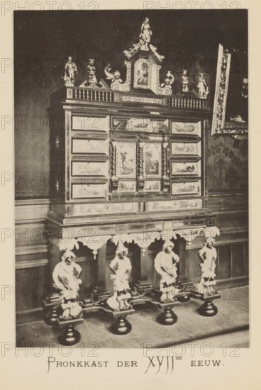 Shower in the house of Christoffel Plantijn, Shower cabinet of the XVIIth century, page, photomechanical print, maker: Joseph Maes, c. 1881 - in or before 1886, paper, collotype, photoprint, height 160 mm x width 110 mm, Print on third unnumbered page after page 88., interior of the house, 'Kunstschrank', A tall ornate cabinet stands on a carved base supported by sculpted figures, the cabinet surface covered in framed painted panels and decorative moldings, topped with balustrade-like detailing and small statuettes, with a central pediment featuring additional sculptural elements and a small statue at its peak; the furniture is placed against a wall with paneling and a partially visible framed picture leaning at an angle, and the photograph shows the floor beneath the cabinet and the surrounding wall area.