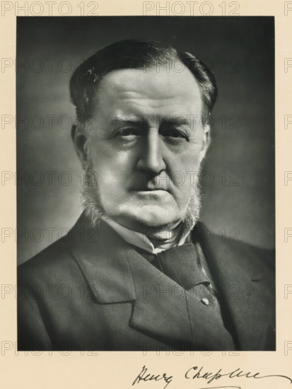 The right honorable Henry Chaplin, photograph, page, inscription: '55. Baker St. London, W.', annotation, photographer: Elliott & Fry, London, c. 1893 - c. 1903, paper, carbon print, height 222 mm x width 171 mm, Person, Henry Chaplin, historical persons (portraits and scenes from the life) ((full) bust portrait), A black and white close-up portrait of an older man showing his head and upper torso, with neatly combed dark hair, prominent sideburns, a serious facial expression, deep-set eyes, and visible facial wrinkles; he is wearing a dark suit jacket, a vest, and a high-collared shirt with a cravat, and the image has a light border around it.