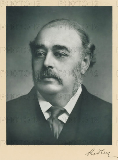 The right honorable Viscount Ridley, photograph, page, inscription: 'Newcastle-on-Tyne', annotation, photographer: Ruddock, London, c. 1893 - c. 1903, paper, carbon print, height 227 mm x width 171 mm, Person, Matthew White Ridley, historical persons (portraits and scenes from the life) ((full) bust portrait), A black-and-white portrait of a middle-aged man shown from the shoulders up, facing slightly to the viewer's left, with a high forehead and receding hairline, full sideburns and a thick moustache, wearing a dark jacket and a white shirt with a loosely knotted necktie, set against a plain, softly shaded background and framed by a light border.