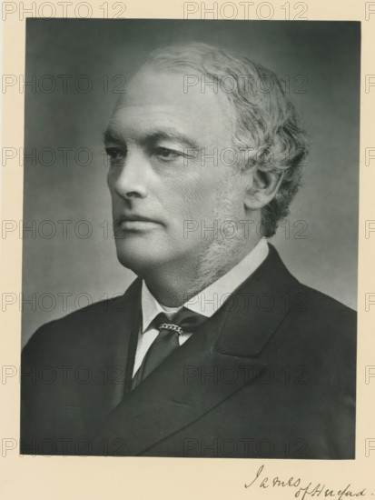 The right honorable lord James of Hereford, photograph, page, annotation, inscription: '25, Old Bond St. London, W.', photographer: Bassano & Co., London, c. 1893 - c. 1903, paper, carbon print, height 227 mm x width 171 mm, Person, Henry James, historical persons (portraits and scenes from the life) ((full) bust portrait), A black and white portrait photograph of an older man shown in profile facing left, with short wavy hair and sideburns, wearing a dark suit jacket, a white shirt with a visible collar, and a necktie secured with a decorative tie clasp; the background is plain and shaded, and the image is bordered by a lighter matte.