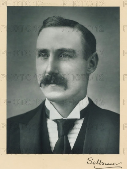 The right honorable the earl of Selborne, photograph, page, annotation, inscription: '25, Old Bond St, London, W.', photographer: Bassano & Co., c. 1893 - c. 1903, paper, carbon print, height 228 mm x width 171 mm, Person, William Waldegrave Palmer, historical persons (portraits and scenes from the life) ((full) bust portrait), A black-and-white portrait of a man shown from the chest up, wearing a dark suit jacket over a vest and a high white collar with a dark tie, featuring a neatly groomed mustache and short hair combed to the side, with a neutral facial expression and a plain background.