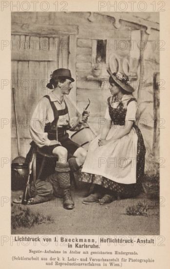 Man and woman in traditional clothing sitting in a photo studio, page, photomechanical print, inscription: 'Negativ-Aufnahme im Atelier mit gezeichnetem Hindergrunde, Beilage zu Eder's Jarhbuh für Photographie 1890.', photographer: KK Lehr- und Versuchsanstalt für Photographie, cliché maker: Baeckmann, J., c. 1885 - in or before 1890, KK Lehr- und Versuchsanstalt für Photographie, Baeckmann, photographer, cliché maker, paper, photolithography, height 146 mm x width 97 mm, Print on ninth unnumbered page after page 400., historical persons, historical persons - BB - woman, studio requisites, A sepia-toned photograph of a man and a woman seated facing each other in front of a rustic backdrop depicting a wooden door and stone wall; the man wears a brimmed hat, a light long-sleeved shirt with suspenders, knee-length shorts, thick knitted socks, and boots, and he holds a curved pipe in one hand while a rifle and a metal container rest on the ground beside him; the woman wears a wide-brimmed ...
