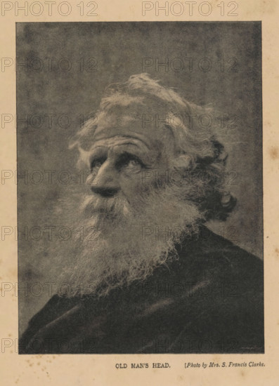 Old man's head, Portrait of an unknown man, page, photomechanical print, photographer: S. Francis Clarke, cliché maker: anonymous, c. 1889 - in or before 1894, S. Francis Clarke, photographer, cliché maker, paper, autotypie, height 152 mm x width 112 mm, Print opposite title page., historical persons, A sepia-toned portrait of an elderly man shown from the shoulders up, facing slightly left, with a long, full beard and wavy hair that is tousled and extends past his ears, deep-set eyes looking upward, pronounced forehead wrinkles, a prominent nose, and a textured dark background surrounding his head and shoulders.