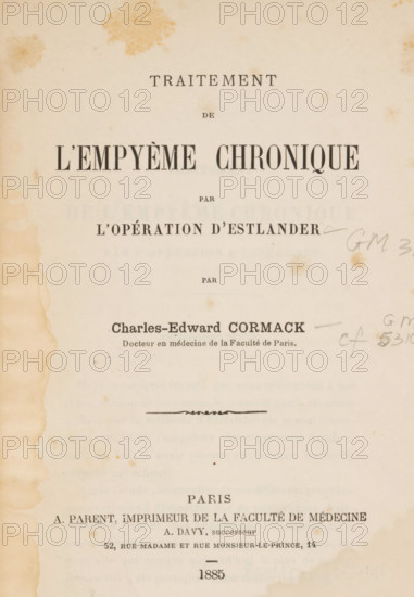 Traitement de l'empyème chronicique par l'opération d'Estlander, by Charles-Edward Cormack, book, number: 'c. 147', date: 'MAY, 2003', collector's mark: '..., 1693', number: '20415669', annotation: 'photographs, med', number: 'GM 3171, gm, c 5310', writer (clerical worker): Charles Edward Cormack, printer (person): A. Parent (printer), Paris, 1885, writer (clerical worker), printer (person), paper, printing, albumen print, height 238 mm x width 156 mm x thickness 13 mm, A yellowed book page with visible age spots and stains, darker discoloration along the left edge, printed large bold headings near the top, smaller printed lines and a centered decorative flourish in the middle, a hand-drawn pencil scribble near the right margin, and more printed lines toward the bottom above a small horizontal dash.