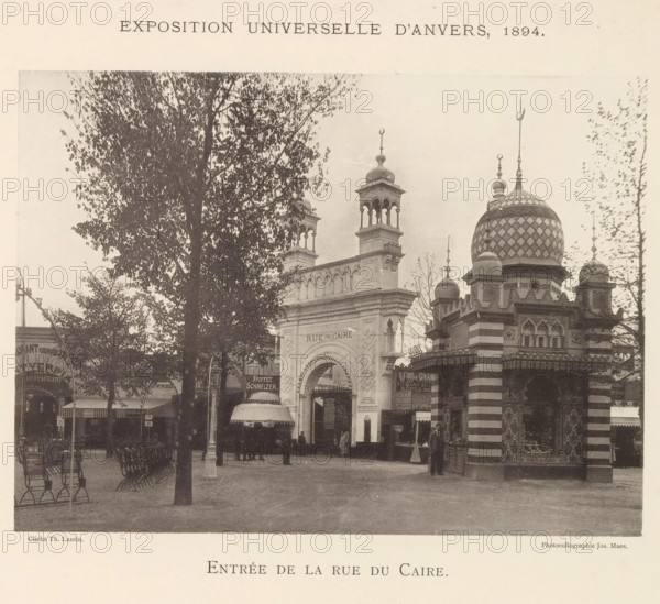 Entrée de la Rue du Caire, Exterieur van het Egypte paviljoen op de wereldtentoonstelling te Antwerpen, page, photomechanical print, photographer: Th. Lantin, Antwerp, printer (person): Joseph Maes, 1894, printer (person), paper, collotype, photogravure, height 160 mm x width 220 mm, façade (of house or building), world fair, world exhibition, Wereldtentoonstelling 1894 (Antwerp), A sepia-toned street scene shows a large ornate archway flanked by decorative towers and a domed pavilion with a patterned surface, finials, and striped lower walls, with trees partially obscuring portions of the architecture and benches arranged in rows in the foreground, several people standing near the arch and pavilion, small awnings and kiosk-like structures at street level, and a wide open paved area in front of the buildings.