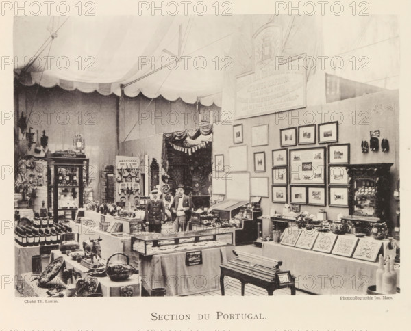 Section du Portugal, Exhibition of Portuguese objects during the world exhibition in Antwerp, page, photomechanical print, photographer: Th. Lantin, Antwerp, cliché maker: Joseph Maes, 1894, paper, collotype, light printing, height 160 mm x width 219 mm, world fair, world exhibition, exhibition, show, A large indoor exhibition space with a scalloped fabric ceiling and tentlike supports houses display tables and cabinets filled with various objects and framed pictures on the walls, including pottery, bottles, carved panels, decorative plates, and small sculptural items; two men stand near the center wearing period clothing and hats among crates and display cases, while shelving units, hanging items, and ornamental furniture occupy the surrounding area, and a curtained doorway and a tall plaque are visible on the rear wall.