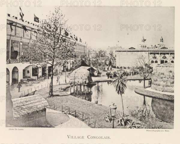 View of a recreated Congolese village during the world exhibition in Antwerp, Village Congolais, page, photomechanical print, photographer: Th. Lantin, Antwerp, cliché maker: Joseph Maes, 1894, paper, collotype, photoprint, height 160 mm x width 219 mm, village, colonial system, world fair, world exhibition, exhibition, show, A sepia-toned scene shows a landscaped area with a winding water canal bordered by grassy banks and a curved path, a thatched hut on stilts standing over the water, a smaller thatched structure nearer the foreground, and a palm-like plant rising beside the canal; on the left a multi-story building with arched ground-level openings and an upper gallery lined with flags and a tree in front, outdoor tables and chairs beneath the arches, and pedestrians on the walkway; in the distance a large classical building with decorative arches and towers is visible, and scattered trees, lampposts, and groups of people populate the grounds.