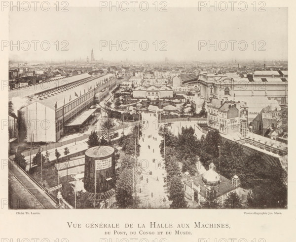 View of the world exhibition in Antwerp, Vue générale de la halle aux machines, du pont, du Congo et du musée, page, photomechanical print, photographer: Th. Lantin, Antwerp, printer (person): Joseph Maes, 1894, printer (person), paper, collotype, photoprint, height 157 mm x width 220 mm, facade (of house or building), world fair, world exhibition, World Exhibition 1894 (Antwerp), A wide elevated view of a cityscape showing a broad tree-lined avenue running toward the center with small figures walking along it, flanked by fenced gardens, paths, and clustered buildings; on the left a long industrial hall with a pitched roof and rows of small vents and flags along its side, and a large cylindrical structure in the foreground; on the right a block of ornate classical buildings with columned facades and adjacent smaller commercial structures; scattered tents, pavilions, and landscaped enclosures occupy the middle ground, while a dense spread of rooftops and church spires fills the distant ...