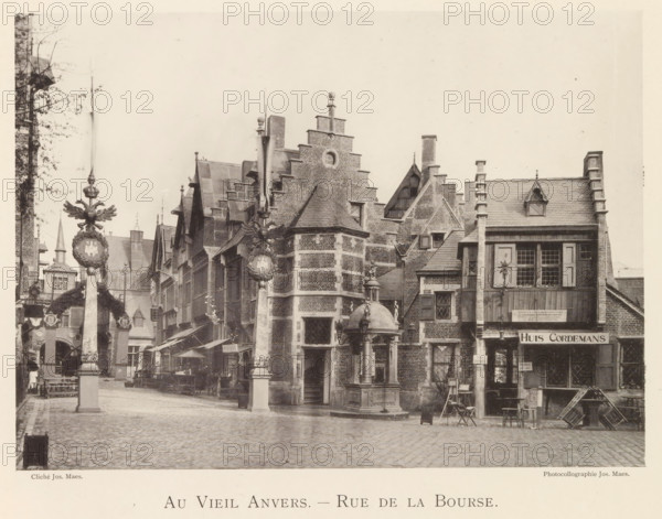 Beursstraat in Antwerp, Au vieil Anvers - Rue de la Bourse, page, photomechanical print, photographer: Th. Lantin, Antwerp, printer (person): Joseph Maes, c. 1890 - in or before 1894, printer (person), paper, collotype, photoprint, height 158 mm x width 220 mm, street, facade (of house or building), A cobblestone street lined with tall brick buildings featuring stepped gables, dormer windows, and chimneys, with a square stone fountain topped by a small domed canopy and a statue in the center foreground, decorative stone pillars topped with ornamental crests and winged figures standing along the street, awnings and market stalls with tables and chairs set beneath them, wooden shutters and paned windows on the building facades, a small wooden balcony and a storefront with an overhanging roof, stacked wooden crates and a folding chair near the right side, and a narrow alleyway and arch visible between the buildings on the left.