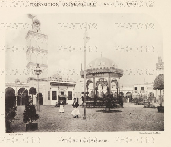 Exterior of the Algeria pavilion at the World Exhibition in Antwerp, Section de l'Algérie, page, photomechanical print, photographer: Th. Lantin, Antwerp, printer (person): Joseph Maes, 1894, Th. Lantin, Joseph Maes, photographer, printer (person), paper, collotype, photoprint, height 163 mm x width 219 mm, facade (of house or building), world fair, world exhibition, A sepia-toned scene shows an open courtyard with ornate pavilion structures and a tall intricately detailed tower, arched colonnades along the background, decorative domes and a small turreted tower at one side, a central octagonal kiosk with scalloped arches and a domed roof, a tall lamp post and another pole rising near the kiosk, potted trees and plants arranged around the paved ground, two men wearing dark jackets and long white aprons walking in the foreground, and various architectural details such as carved cornices, window openings, and ornamental railings visible on the buildings.