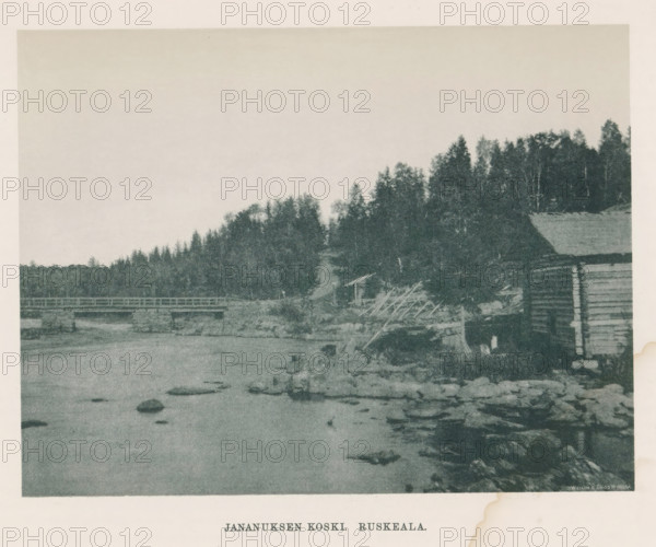 Jananuksen koski - Ruskeala, View of a river in Ruskeala, page, photomechanical print, photographer: Impi Backman, cliché maker: anonymous, printer (person): Weilin & Göös, c. 1888 - c. 1893, printer (person), paper, autotypie, height 157 mm x width 206 mm, river, bridge, civic architecture, edifices, dwellings, Karelia, A grainy landscape image showing a body of water in the foreground with scattered rocks and a shoreline, a wooden bridge crossing the water toward the left, a hillside covered with dense trees and foliage along the right and center, and a rustic wooden structure partially visible on the right edge.