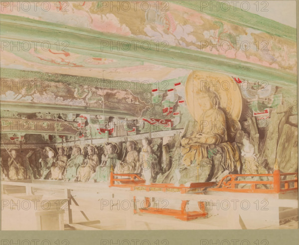 Sculptures in the Chion-in temple in Kyoto, photograph, page, Chion-in, Japan, c. 1887 - in or before 1897, photographer, colorer (graphic design artist), Kinki, Kyoto, paper, albumen print, hand coloring, photographie peinte, height 186 mm x width 243 mm, Photo for page 179., sculpture, temple, shrine, Hinduism, Buddhism, Jainism, Buddha, founder of Buddhism, interior, representation of a building, A row of carved stone figures seated against a decorated wall, with a larger seated figure on a raised rock formation at the right, all beneath an ornate painted ceiling with flowing cloud and dragon motifs in muted greens, pinks, and golds, with patterned horizontal beams and decorative brackets featuring red and green accents, and a low wooden railing painted bright red in front of the figures.