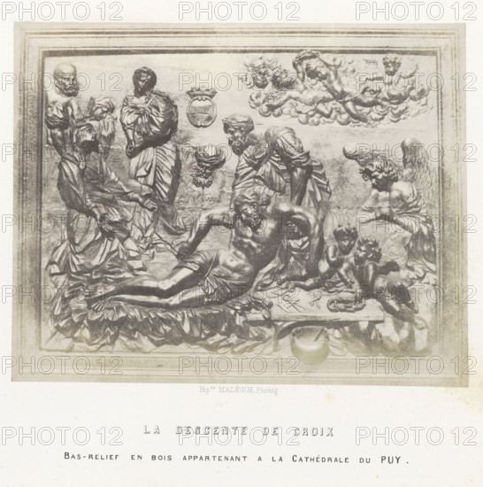 La descente de croix, Bas-relief with the Descent from the Cross, from the cathedral of Le Puy-en-Velay, photograph, page, inscription: 'Bas-relief en bois appartenant a la Cathédrale du Puy.', number: 'PL. 22.', photographer: Hippolyte Malègue, France, c. 1850 - in or before 1857, paper, salted paper print, height 148 mm x width 188 mm, descent from the cross: Christ is taken down from the cross, usually by Nicodemus and Joseph of Arimathaea who are standing on the ladders (both arms of Christ detached), sculpture (relief, sculpture), A rectangular carved panel framed by a molded border shows a group of sculpted human figures in draped clothing arranged around a reclining male figure with a muscular torso, his head bowed and one arm extended; nearby figures include standing and kneeling adults with beards and head coverings, an angelic winged figure leaning forward, and two small childlike figures seated close together; above them a cluster of cloud forms contains reclining cherubic f...