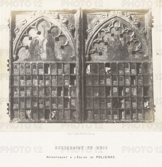 Wooden reliquary from a church in Polignac, Reliquaire en bois, photograph, page, number: 'PL. 26.', inscription: 'appartenant a l'Eglise de Polignac.', photographer: Hippolyte Malègue, France, c. 1850 - in or before 1857, Hippolyte Malègue, photographer, paper, salted paper print, height 158 mm x width 194 mm, relics (and reliquaries), A rectangular wooden panel with two hinged doors, each door topped by a gothic arched panel featuring carved floral tracery and faded painted figures, sits above a grid of small square compartments framed by rope-like moldings, some compartments holding worn paper fragments, while the wood shows aged patina and areas of darker wear; the panel rests on a light background with a wide margin beneath.
