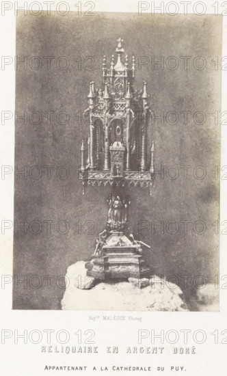 Silver reliquary from the cathedral of Le Puy-en-Velay, Reliquaire en argent doré, photograph, page, number: 'PL. 7.', inscription: 'appartenant a la Cathédrale du Puy.', photographer: Hippolyte Malègue, France, c. 1850 - in or before 1857, paper, salted paper print, height 178 mm x width 123 mm, relics (and reliquaries), A tall ornate metallic reliquary with a multi-tiered, spired canopy stands on a decorative columnar base placed on a rough stone platform; the reliquary features arched openings, slender columns, finial-like turrets, intricate latticework and sculptural details along its tiers, and a broad embellished base with molded panels and ornamental feet, all shown against a plain, textured backdrop.