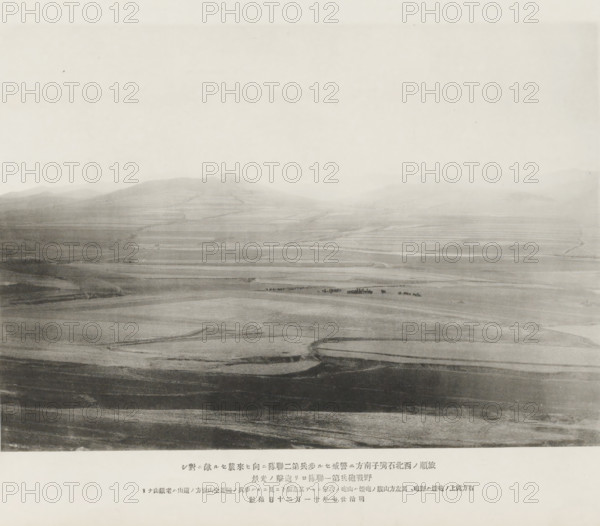 Cannonade of the first shield artillery regiment upon the Chinese advancing to attack the second infantry regiment stationed on the S. of Shihtsuytse, NW of Port Arthur, page, photomechanical print, inscription: 'The smoke on the hill on the right, The mountain in the distance is Laoteeshan.', inscription: 'The fall of Port Arthur.', photographer: Ordnance Survey, Manchuria, cliché maker: Kazumasa Ogawa, Japan, 1894-11-20, paper, collotype, photoprint, height 195 mm x width 277 mm, firearms: cannon, army 'en route', A wide, hazy landscape view with gently rolling hills and terraces fading into a pale sky, showing layered bands of darker and lighter ground across the foreground and midground, faint winding paths or tracks cutting through the fields, a small cluster of dark shapes near the center that appear distinct against the lighter terrain, and a broad expanse of open land stretching toward distant, softly outlined hills under a bright, featureless sky.