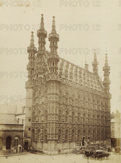 Hôtel-de-ville de Louvain, City Hall of Leuven, photograph, page, Louvain, c. 1862 - c. 1872, photographer, paper, albumen print, albumendruk, height 201 mm x width 145 mm, Photo on page 35., townhall, façade (of house or building), Stadhuis (Leuven), A large ornate stone building with multiple tall spires and pinnacles rises from a street, its façade covered in gothic arches, niches, and sculpted figures. The roofline features a steeply pitched section with numerous decorative dormers and finials, and crenellated balustrades run along the upper levels. At ground level a set of stone steps and an entrance with carved railings are visible, and a carriage with horses is parked on the street beside the building. Adjacent lower buildings with plain facades and arched doorways flank the ornate structure, and the scene is captured in a monochrome, aged photograph style.
