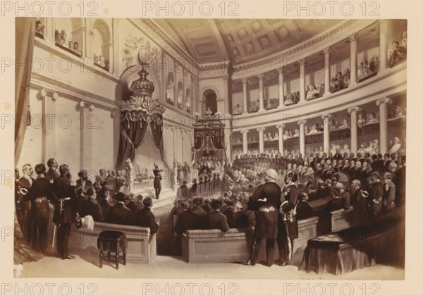 Photographic reproduction of a design of Léopold II of Belgium taking the oath during his inauguration on December 17, 1865 in Brussels, Presentation de Serment de SM Léopold 11, photograph, reproduction, This photo is part of a cover with fourteen photos., inscription: '17 Décembre 1865., Chambre des Représentants Bruxelles', photographer: Ghémar Frères, Brussels, after design by anonymous, c. 1861 - in or before 1866, paper, albumen print, height 166 mm x width 249 mm, Person, Leopold II (King of the Belgians), king, installation of a ruler, Period, 1865-12-17, A large, sepia-toned interior scene of an ornate, domed hall filled with many formally dressed people seated and standing on tiered balconies and in the main floor area, with tall columns and decorative molding lining the curved walls. At the focal point a raised platform is framed by heavy draped canopies topped with ornate crowns and decorative finials, flanked by sculpted pedestals and a throne-like chair. Numerous men in d...