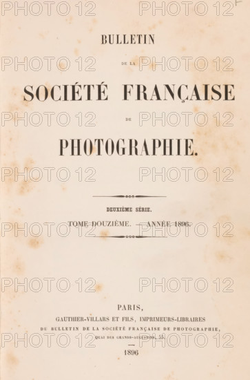 Bulletin de la Société française de photographie, book, inscription: 'Collection Jahel', publisher: Gauthier-Villars & Fils, Paris, 1896, pasteboard, biological material, paper, leather, printing, autotypie, collotype, agate marbled paper, spanish marbled paper, photoaquatint, height 251 mm x width 164 mm x thickness 38 mm, A faded, aged paper page with scattered brown foxing marks and a centered layout of large dark printed lines and decorative dividers, the top and middle areas featuring bold, wide serif word blocks and smaller lines of narrow type, with ornamental horizontal flourishes above and below a midsection, and additional smaller printed lines and blocks toward the lower area, all on a pale beige background with uneven discoloration around the edges.