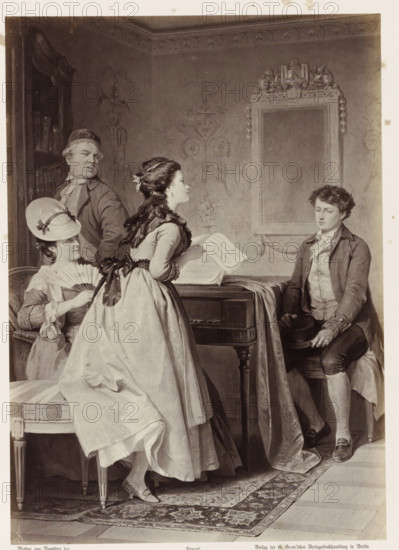 Hermann and the Neighbor's Daughters, Photographic reproduction of a painting by AG von Ramberg, depicting Hermann with the neighbor's daughter, photograph, reproduction, Part of Album with photographic reproductions of paintings by AG von Ramberg after the work 'Hermann and Dorothea' by J.W. von Goethe., photographer: Franz Hanfstaengl, after painting by Arthur Georg von Ramberg, publisher: G.-Grote'sche Verlagsbuchhandlung, Berlin, 1871 - 1872, Franz Hanfstaengl, Arthur Georg von Ramberg, G.-Grote'sche Verlagsbuchhandlung, paper, albumen print, height 284 mm x width 202 mm, adult woman, youth, adolescent, making music, musician with instrument, A grayscale image of an interior scene showing four people gathered around a small table or piano draped with a cloth, with ornate wallpaper and a large framed mirror on the wall. A standing young woman in a full dress with bows and a ribbon in her hair faces toward a seated young man who is wearing a coat and holding a hat on his knee, lookin...