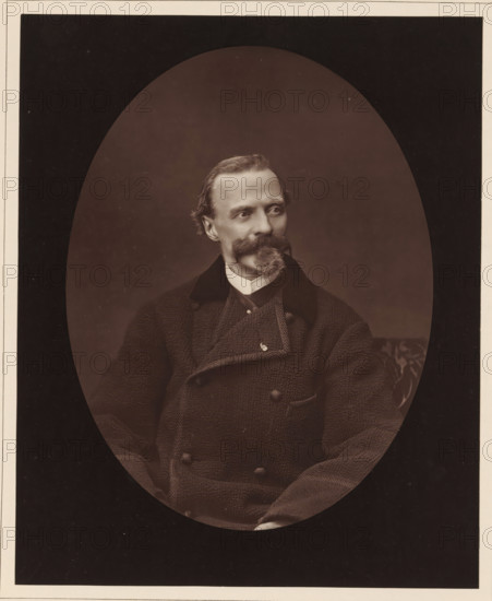 Cham. Ne a Paris, le 26 janvier 1819, mort a Paris, le 6 septembre 1879, Portrait of Charles Amédée de Noé, page, photomechanical print, inscription: '126, boul. Magenta.-Paris.', photographer: Ferdinand Mulnier, cliché maker: Goupil & Cie., c. 1876 - in or before 1879, paper, Woodburytype, Woodburytypepie, height 230 mm x width 186 mm, Person, Cham, portrait, self-portrait of graphic artist, caricatures (human types), A sepia-toned oval portrait of a seated man with a neatly groomed mustache and pointed goatee, wearing a textured double-breasted coat with a high collar and a visible shirt collar underneath, his head turned slightly to the viewer's left, the background dark and plain with a faint patterned cushion visible at the right edge.