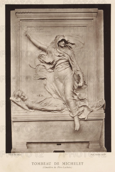 Tomb for Jules Michelet by Marius Jean Antonin Mercié, Tombeau de Michelet (Cimetiere du Pere-Lachaise), page, photomechanical print, inscription: '126, boul. Magenta.-Paris.', photographer: Charles Michelez, cliché maker: Goupil & Cie., after sculpture by Marius Jean Antonin Mercié, publisher: Ludovic Baschet, c. 1876 - in or before 1879, Marius Jean Antonin Mercié, after sculpture by, paper, Woodburytype, Woodburytypie, height 257 mm x width 182 mm, grave, tomb, Paris, Cimetière du Père-Lachaise, A sculpted relief set within a rectangular stone frame shows a draped female figure stepping forward with one arm extended upward and the other lowered, her flowing garments creating sweeping folds and billows around her body and head. At her feet and leaning against the base, a reclining male figure lies on a cushion with his head turned to the side and one hand resting on his chest, his form partially covered by drapery. The relief includes an architectural surround with molded edges and a...