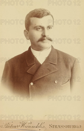Portrait of an unknown, possibly Meir Wachenheimer, photograph, Portrait of an unknown man with a moustache, thick white collar, and overgarment with two fastening buttons, photographer: Anton Hruschka, Strasbourg (France), 1870 - 1920, paper, gelatin silver print, developed gelatin silver print, height 165 mm x width 110 mm, Period, A sepia-toned portrait of a man shown from the chest up wearing a dark double-breasted coat with wide lapels and a high white collar, his hair neatly combed to the side and a thick mustache above his closed lips, his expression neutral as he looks slightly to his right against a plain light background.