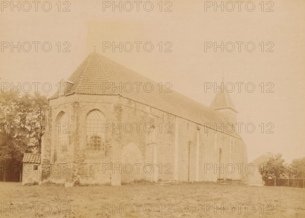 North side of the Church of Vlagtwedde, photograph, annotation: 'Vlagtwedde, north side NH church, Sept 1893', annotation: 'Vlagtwedde', Vlagtwedde, 1893, photographer, Attributed to, paper, pasteboard, albumen print, height 164 mm x width 228 mm, church (exterior), Church of Vlagtwedde, A sepia-toned photograph shows the side and partial front of a large brick building with a steep tiled roof and a small dormer near the roof ridge. Tall arched windows with visible panes are set into the brick wall, and vertical buttresses run along the building's side. A square tower with a pointed tiled roof and a finial rises near the rear. Trees are visible behind and beside the building, and a grassy foreground stretches across the bottom of the image.
