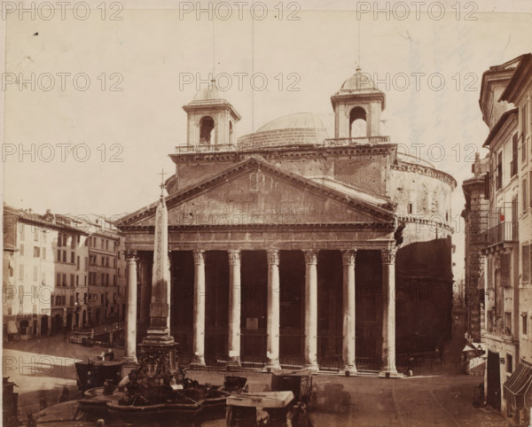 View of the Pantheon and the Macuteo obelisk in Rome, Italy, photograph, inscription: 'Leskast pl. I', inscription: 'Chagrijn, M. Chagrijnig, ...', collector's mark: 'RIJKS SCHOOL FOR ART AND HANDY, GROUP', inscription, photographer: attributed to Giorgio Sommer, Rome, after sculpture by anonymous, 1857 - 1914, Giorgio Sommer, photographer, after sculpture by, Attributed to, pasteboard, paper, albumen print, height 320 mm x width 479 mm, square, circus, church (exterior), obelisk, needle, Pantheon, Piazza della Rotonda, A wide sepia-toned photograph shows a classical temple facade with a triangular pediment and a row of tall fluted columns supporting an entablature, flanked by two square bell towers topped with domes and a large rounded dome visible behind them; in front of the temple stands an obelisk mounted on an ornate fountain base with sculpted figures and water basins, horse-drawn carriages and covered carts are parked nearby, multi-story buildings with shuttered windows line th...