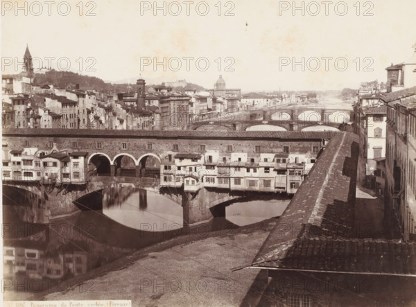 View of the Arno and the Ponte Vecchio in Florence, Italy, Panorama da Ponte vechio. (Firenze), photograph, address: 'DEPOT A FLORENCE, J. BRECKER, VIA MAGGIO 15', address: 'GIORGIO SOMMER, STUDIO MONTE DI DIO 4., MAGAZZINO S. GATERINA 5., NAPOLI', number: 'No. 1807.', photographer: Giorgio Sommer, Florence, 1857 - 1914, Tuscany, pasteboard, paper, albumen print, height 305 mm x width 377 mm, landscape with bridge, viaduct or aqueduct, river, bridge in city with structures, ie shops, houses, eg Ponte Vecchio in Florence, Ponte Vecchio, Arno, A wide river scene with multiple stone bridges crossing the water, the nearest bridge featuring arches and small buildings projecting from its sides, their facades showing windows, shutters, and tiled roofs; the water below reflects the arches and buildings. Along the riverbanks there are rows of closely packed multi-story buildings with varied rooflines and external stairways, and a long roofed structure running parallel to the river in the midgro...