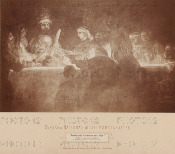 Rembrandt Harmensz van Rijn. Ziskas sammansvärjning, undermålning till en ofallbordad tafla., Photo reproduction of the painting 'The Oath of the Batavians under Claudius Civilis' by Rembrandt van Rijn, Svenska National-Musei Konstskatter, photograph, reproduction, photographer: Johannes Jaeger, Stockholm, after painting by Rembrandt van Rijn, 1865 - 1890, pasteboard, paper, albumen print, height 287 mm x width 373 mm, Person, picture, painting, Nationalmuseum, A sepia-toned image of a group of people gathered around a long table, with several figures seated and others standing behind them, their faces rendered in soft, painterly light and shadow; one person at the left holds a large, diagonal object that crosses the center, and another hand extends a shallow bowl toward the middle; figures wear robes and head coverings, and a variety of facial hair and hairstyles are visible; the table surface appears covered and reflects light while objects such as cups and dishes sit near the edges;...