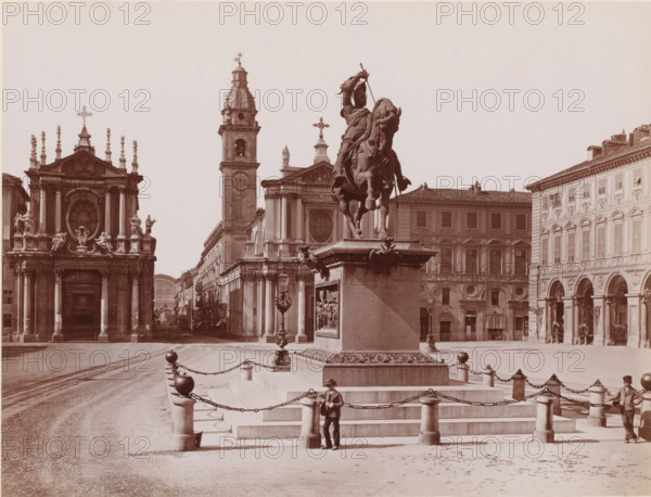 View of the Piazza San Carlo with equestrian statue of Emanuele Filiberto in Turin, Italy, Piazza S. Carlo - Monumento a Emanuele Filiberto, Torino, photograph, number: '85', inscription: 'Brogi', number: '3722.', photographer: Giacomo Brogi (possibly), Turin, Florence, after sculpture by Carlo Marochetti, 1864 - 1881, Carlo Marochetti, after sculpture by, Tuscany, Piedmont, Attributed to, pasteboard, paper, albumen print, height 317 mm x width 445 mm, Person, Filiberto-Emanuele van Savoye, piece of sculpture, reproduction of a piece of sculpture, historical persons, square, circus, equestrian statue, Piazza San Carlo, A large equestrian statue stands atop a tall stone pedestal encircled by chained posts and spherical finials, with carved relief panels on the pedestal and decorative elements at its corners; the mounted figure raises an arm holding a long object while the horse is depicted rearing. Surrounding buildings with classical facades frame a broad open square, including a churc...