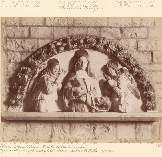 Tympanum addition depicting Martha between two angels by Andrea della Robbia, Florence. National Museum. St. Martha between two Angels., photograph, inscription: 'Italian Renaissance.', inscription: 'CWN.', collector's mark: 'KUNSTNIJVERHEIDSCHOOL QUELLINUS AMSTERDAM FRANS HALSSTRAAT 14.', collector's mark: 'INSTITUUT VOOR KUNST-NIJVERHEIDSONDERWIJS GABRIËL METSUSTRAAT No. 16 AMSTERDAM', Europe, c. 1875 - c. 1900, photographer, paper, pasteboard, albumen print, albumendruk, height 189 mm x width 245 mm, angels, the patroness of housewives, Martha of Bethany, possible attributes: aspergillum, broom, bunch of keys, dragon, ladle, sculpture (relief, sculpture), A stone relief set against a textured brick wall depicting a central robed figure with a covered head and a calm facial expression flanked by two winged figures in robes, each with folded hands and downward gazes, all within a semicircular frame decorated with carved fruits and flowers, a lion head with an open mouth holding a rope...
