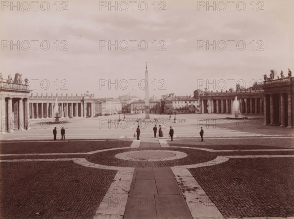Piazza di S. Pietro, vista d, View of St. Peter's Square in Vatican City, Italy, Roma, photograph, number: '8472.', number: '95', photographer: Carlo Brogi (possibly), Vatican City, publisher: attributed to Edizioni Brogi, Florence, 1881 - 1900, Carlo Brogi, Edizioni Brogi, photographer, publisher, Tuscany, Attributed to, pasteboard, paper, albumen print, height 317 mm x width 445 mm, square, circus, St. Peter's Square, A wide open plaza with a central obelisk flanked by two long colonnades topped with statues and balustrades, fountains with jets of water at each side near the colonnades, paved ground with concentric circular stone patterns in the foreground, several small groups of people standing and walking across the plaza dressed in dark coats and hats, low buildings and rooftops visible beyond the obelisk, and a sky filled with light clouds above.