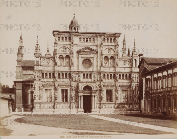 Facciata della Chiesa, Façade of the Certosa di Pavia, Italy, Certosa di Pavia, photograph, collector's mark: 'VOSMAER', number: '3851.', Pavia (city), publisher: attributed to Giacomo Brogi, 1856 - 1881, Giacomo Brogi, photographer, publisher, Lombardy, Attributed to, pasteboard, paper, albumen print, height 315 mm x width 421 mm, abbey, monastery, convent, Roman Catholic church, Pavia (province), A wide frontal view of an ornate stone church facade with multiple levels of arches, columns, statues, and decorative reliefs, flanked by tall spires and smaller towers, a central entrance with columns beneath a pediment and a large circular window above, a domed cupola near the top, adjacent buildings with tiled roofs on either side, a grassy foreground with a curved path leading toward the entrance, and a clear pale sky above.