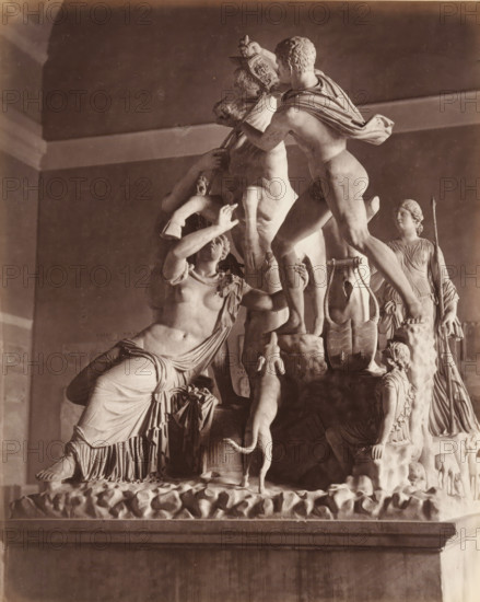 Museo di Napoli - Toro Farnese, Farnese Stier, album page, photograph, This photo is part of an album., number: '1501', workshop stamp: 'Giorgio Sommer, Largo Vittoria, Napoli', photographer: Giorgio Sommer, Naples, 1874 - in or before 1879, paper, albumen print, albumendruk, height 251 mm x width 199 mm, sculpture, Amphion and Zethus avenge their mother by tying Dirce to the horns of a bull, A stone sculpture group on a raised rectangular base shows multiple human figures and animals in a classical style, with a central rearing bull whose head is held by a standing male figure draped with a cloth over his shoulder; a reclining female figure with flowing garments reaches upward toward the bull while another partially visible figure supports the animal from behind; a small dog stands on its hind legs at the bull's side; a female figure in a long dress stands to the right holding a long thin object; carved decorative elements and drapery folds are visible across the composition, and the ...