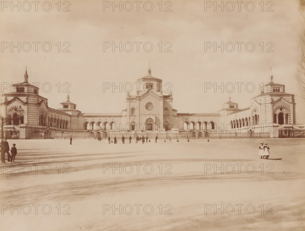 Veduta generale del. famedio, Cimitero Monumentale, Milan, Italy, photograph, Italy., caption: '9646. MILANO - (Cimitero Monumentale) Vedura generale del. Famedio', caption: '(EDIZIONI BROGI)', photographer: Edizioni Brogi, Florence, publisher: Giacomo Brogi, c. 1860 - c. 1890, Tuscany, pasteboard, paper, albumen print, height 252 mm x width 198 mm, height 330 mm x width 510 mm, Lombardy, A wide pale photograph of a large symmetrical stone building with a central tower flanked by lower wings and matching end pavilions, each pavilion topped with a small spire; the façade shows arched openings, striped stonework, decorative columns, and a large circular window in the center tower above an ornate main entrance; a low fence runs along the front of the building with several pedestrian gates; an open paved foreground stretches to the camera with faint surface markings and long shadows; small groups of people and a few solitary figures are scattered near the building and along the foreground,...