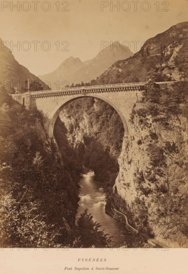 PYRÉNÉES, Pont Napoléon à Saint-Sauveur', Luz-Saint-Sauveur, France, photograph, Frontal view of the Pont Napoleon, an arch bridge built in 1860., caption: 'PYRÉNÉES, date: '11, 12 October 1884.', caption: 'LAFONT LIBRAIRE ÉDITEUR, 40 ALLÉE D'ETIGNY A LUCHON', vendor: Lafont, Luchon, 1884-10-11 - 1884-10-12, Lafont, photographer, vendor, pasteboard, paper, albumen print, albumendruk, height 276 mm, width 212mm x width 338mm, height 398 mm, Pyrenees, A stone arch bridge spans between two steep rocky cliffs above a narrow river flowing through a deep gorge, the bridge showing textured masonry and a balustrade along its roadway, with vegetation and trees clinging to the cliff faces and surrounding the gorge, a winding path or retaining wall visible along the right cliff beside the water, distant mountain peaks rising in the background under a pale sky.