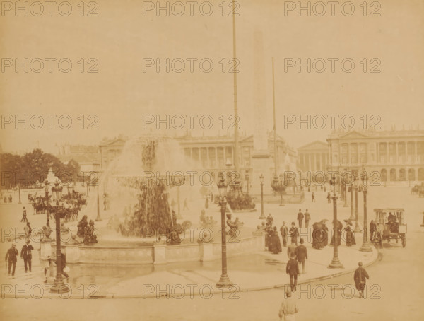 Place de la Concorde, Paris, photograph, View of the square with a large fountain in the middle and passers-by., inscription: '79 PARIS - Place de la Concorde', number: '19.', signature: 'X. Phot.', c. 1870 - c. 1900, photographer, pasteboard, paper, albumen print, albumendruk, height 211 mm, width 273 mm x width 446 mm, height 343 mm, A wide plaza scene shows a large ornate fountain with water cascading from its upper basin into a lower pool, surrounded by sculpted figures and decorative railings, with several tall lampposts positioned around the fountain and plaza; an obelisk rises behind the fountain flanked by flagpoles, and classical buildings with columns and detailed facades form the background; many people in period clothing are walking, standing, and sitting throughout the plaza, with horse-drawn carriages and a few clustered trees visible at the edges.
