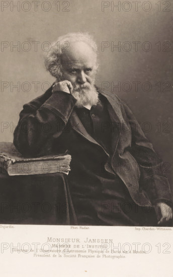 Monsieur Janssen, Portrait of Pierre Janssen, page, photomechanical print, inscription: 'Membre de l'Institut Telefoon de l'Observatoire d'Astronomie Physique de Paris sis à Meudon, Prèsident de la Sociéte' Française de Photographie.', photographer: Félix Nadar, Paris, cliché maker: Dujardin, printer (person): Chardon-Wittmann, c. 1882 - in or before 1892, printer (person), paper, photoaquatint, height 142 mm x width 115 mm, Person, Pierre Jules César Janssen, astronomy (and cosmography), An elderly man with a full white beard and mustache sits leaning his head on his hand, his fingers touching his cheek, wearing a dark coat and jacket with visible folds and textured fabric, his gaze directed slightly downward, beside him a thick, worn book rests on a surface draped with cloth, the background is plain and softly shaded.