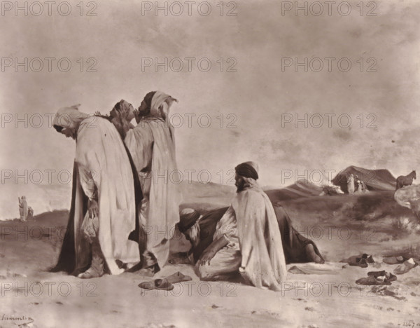 Arabes en prière, Reproduction of Arabes en prière by Eugène Fromentin-Dupeux, reproduction, page, photomechanical print, inscription: 'Eugène Fromentin, Galerie Contemporaine, Littéraire et Artistique, 126, boulevard Magenta, Paris.', cliché maker: Goupil & Cie., after painting by Eugène Fromentin-Dupeux, c. 1871 - in or before 1876, photographer, paper, Woodburytype, height 168 mm x width 217 mm, painting, drawing and the graphic arts, ritual objects and ritual means, non-Christian religions, Three robed figures stand in the foreground with their heads covered, one leaning forward and another touching his face, while two men kneel nearby with covered heads and loose cloaks; scattered sandals lie on the ground around them. In the middle distance a small group of people stands near a low mound of earth or dunes with smoke rising nearby, and a horse stands to the right. The sky above is broad and clouded with a mottled texture and the landscape is flat and sparse with gentle rises.