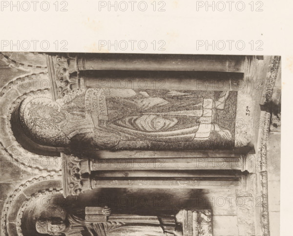 Two mosaics and a sculpture, probably of apostles, from San Marco in Venice, photomechanical print, This print is part of a cover with 79 prints on 53 pages and 2 text pages., number: '217.a', number: 'I.9.a', number: 'J.9a.', photographer: Carl Heinrich Jacobi, Venice, photographer: Ferdinando Ongania, c. 1880 - in or before 1885, paper, collotype, photoprint, height 313 mm x width 394 mm, piece of sculpture, reproduction of a piece of sculpture, architectural detail, St. Mark's Basilica, A sepia-toned photograph of a stone architectural interior showing a large vertical mosaic panel set within an arched recess flanked by carved columns; the mosaic depicts a robed figure with a halo-like patterned head and flowing garments made of small tesserae, and the surrounding stonework includes ornate capitals with scroll and floral motifs and layered arch moldings; below the mosaic a sculpted standing figure in a carved niche is visible with detailed drapery and a carved pedestal, and the imag...
