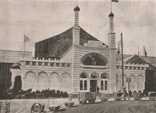 View of the pavilion of the Portuguese colonies at the 1885 World's Fair in Antwerp, Façade du Pavillon des Colonies Portugaises, page, photomechanical print, Antwerp, clichémaker: Meisenbach's Autotype Company, c. 1880 - in or before 1885, Meisenbach's Autotype Company, photographer, clichémaker, paper, autotypie, height 167 mm x width 233 mm, world fair, world exhibition, Wereldtentoonstelling 1885 (Antwerp), Period, 1885-05-02 - 1885-11-02, A large ornate building facade with striped vertical towers topped by bulbous domes, arched windows and decorative circular windows, a semicircular decorative panel above the entrance, a row of arched recesses along the wall, and columns with ornate capitals; a tall lamp post with a hanging light stands near the entrance; several small wheeled carts and platforms line the street in front, along with a cylindrical object on the pavement; flags fly on poles above parts of the structure and nearby roofs; a person stands in the entranceway and anothe...