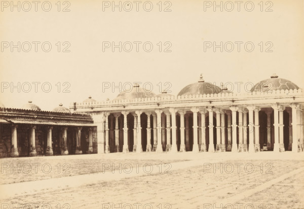 View of a mosque at Sarkhej Roza near Ahmedabad, Sirkhej.- The Mosque, fro the North-east, photograph, page, number: '48.', photographer: Thomas Biggs, Sarkhej Roza, c. 1856 - in or before 1866, Gujarat, paper, albumen print, height 136 mm x width 187 mm, temple, shrine, Islam, Mohammedanism, A long colonnaded building with a series of tall, evenly spaced pillars supporting a horizontal entablature and a row of domed roofs above, the domes topped with small finials and showing visible surface patterns, an open arcade beneath the entablature with shadowed recesses and visible architectural details on the pillars and arches, a broad open ground in front with faint textured paths across it, and a person seated near one end of the colonnade.